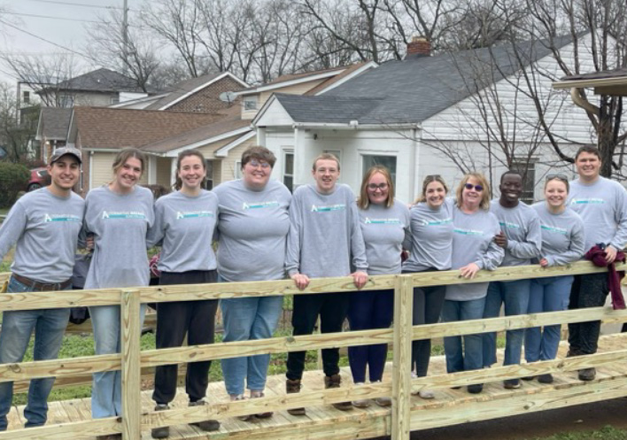 Alternative Break participants on a ramp that they built during a Spring Break service project