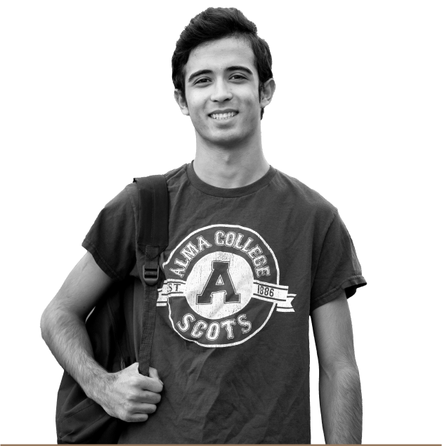 Portrait of a student wearing an Alma College t-shirt with a backpack over one shoulder and smiling at the camera.