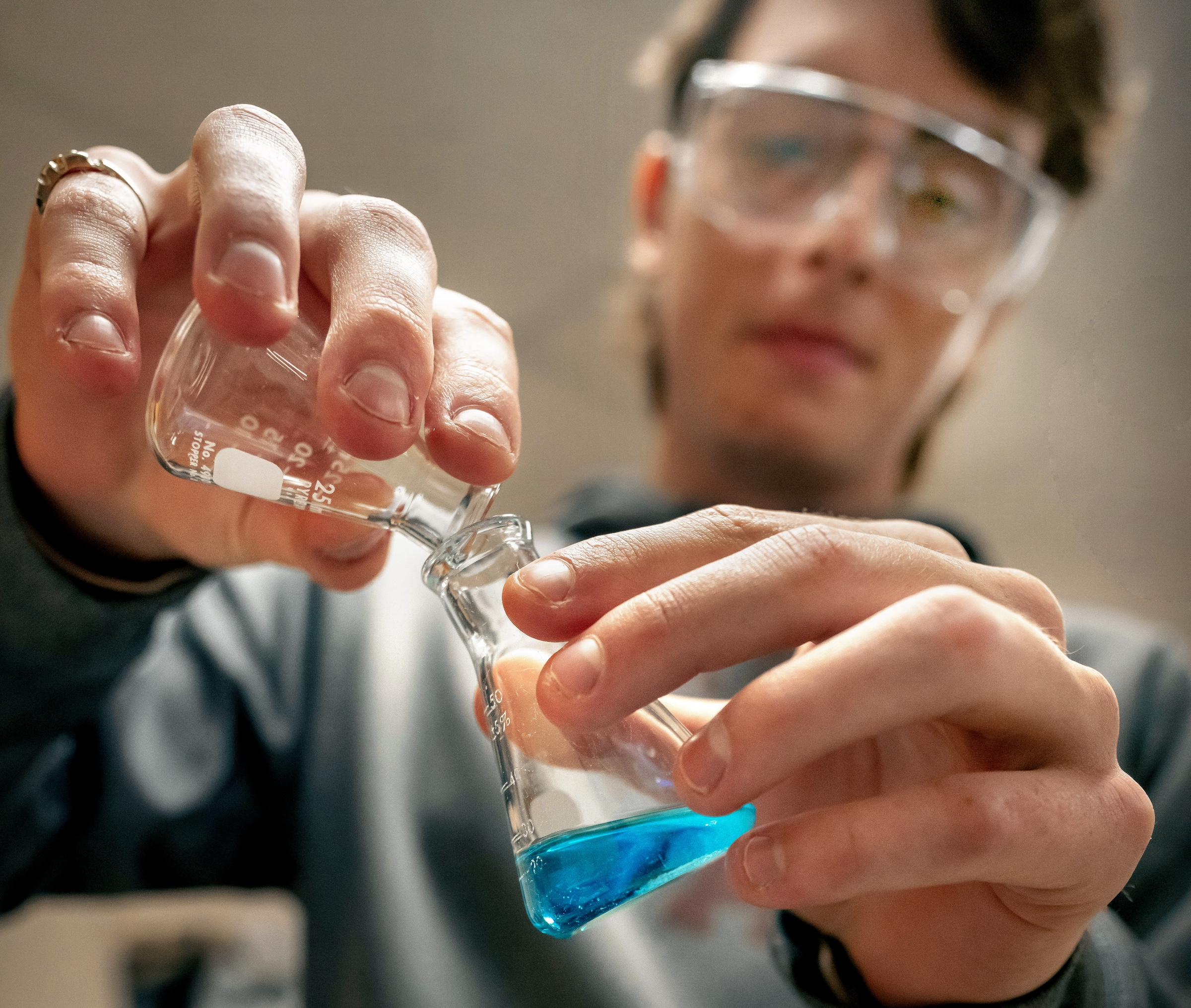 Students participating in a college geology class, using Play-Doh to create models.