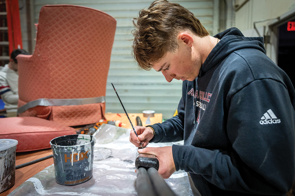 Student painting props in the set design studio in the Theatre Department.