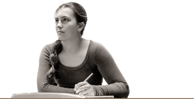 Female student looking to the side, holding a pencil and taking notes